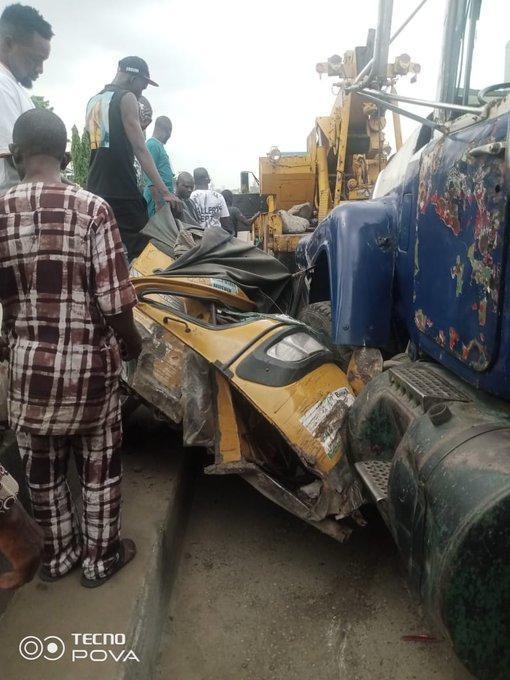 Truck crushes keke, damages car